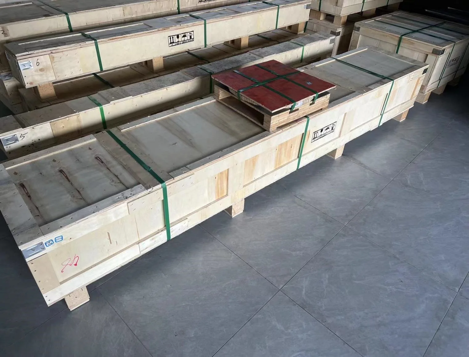 Metal plates packed in wooden shipping crates for industrial delivery