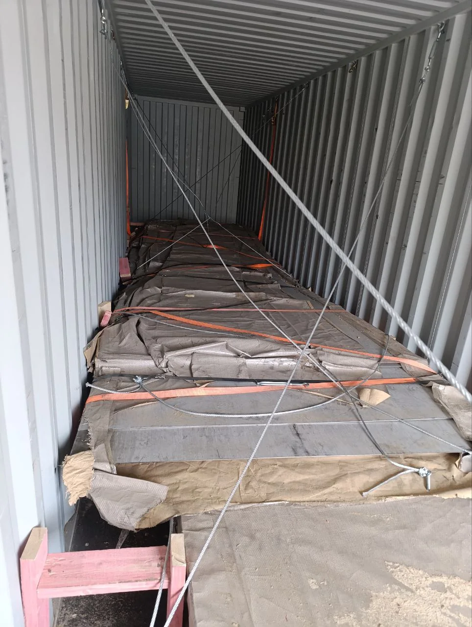 Industrial metal sheets protected and secured inside a shipping container