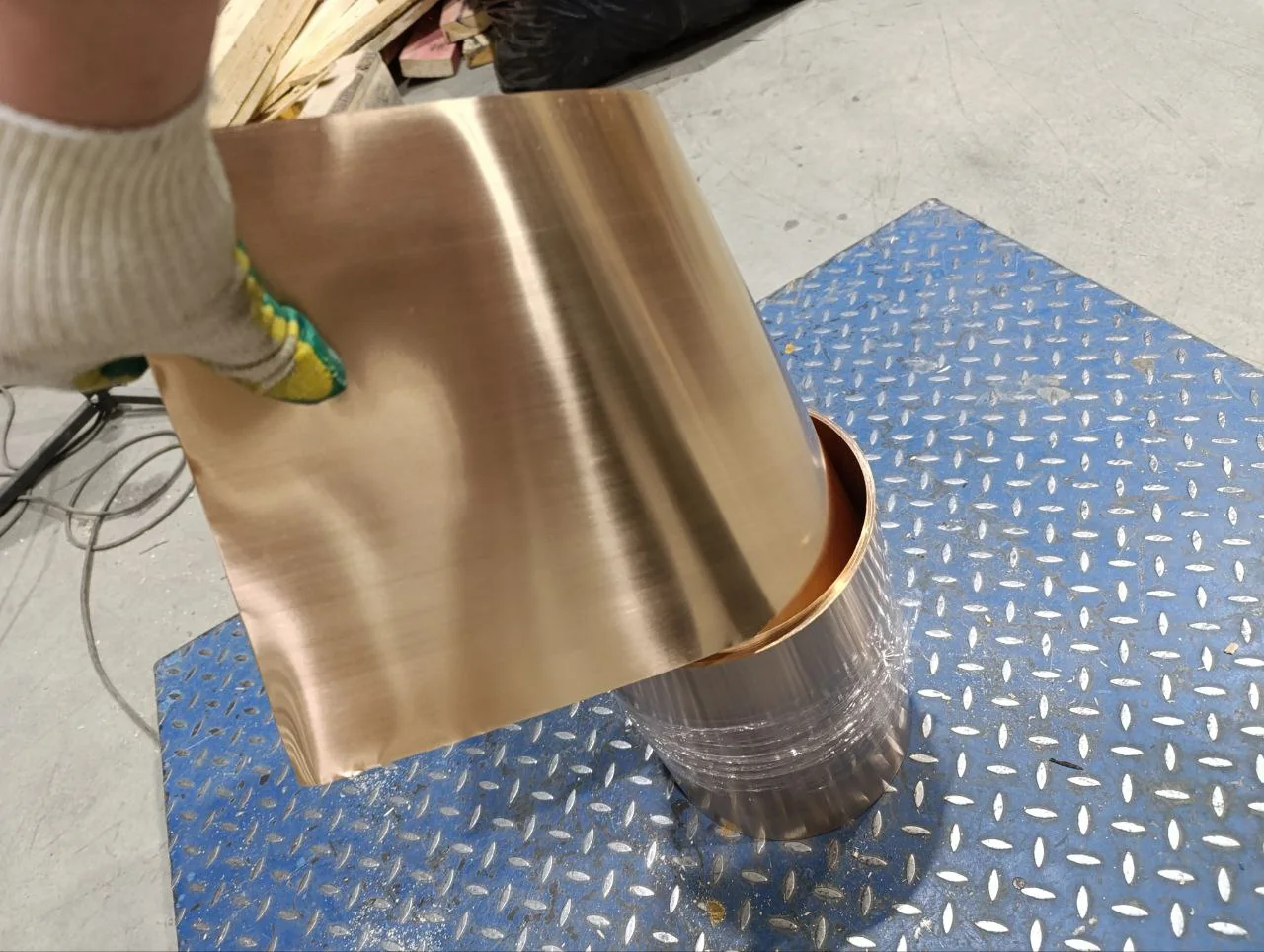 Copper-alloy strip being uncoiled for dimensional inspection